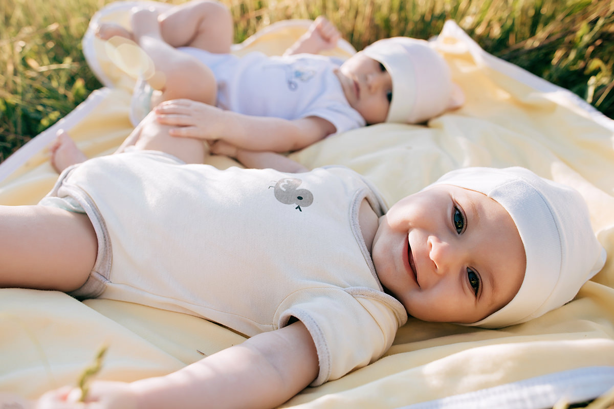 Babies Laying on a Blanket on the Grass